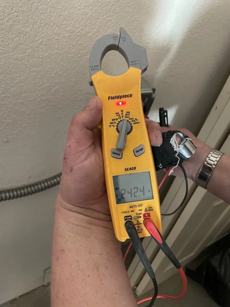 Voltage testing with clamp meter during Electrical Installation Services in Dumas